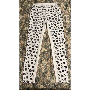 white leopard-print athletic leggings from the brand Allfenix. leopard spots